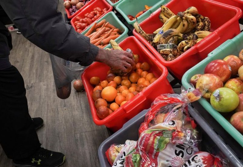 A community member grabs a piece of fruit at The Community Assistance Center food pantry, in Atlanta, Georgia, U.S. April 12, 2023. REUTERS/Megan Varner