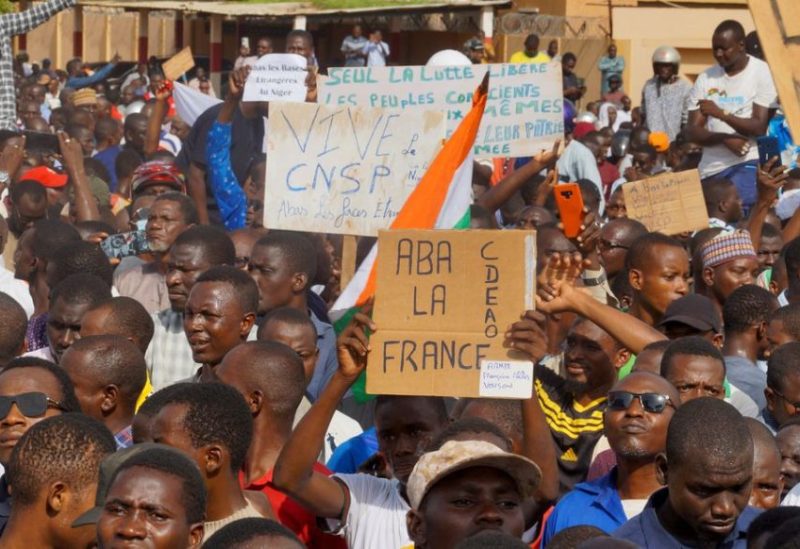 Demonstrators gather in support of the putschist soldiers in the capita Niamey, Niger July 30, 2023. Signs read "long live CNSP", "down with France, ECOWAS". REUTERS