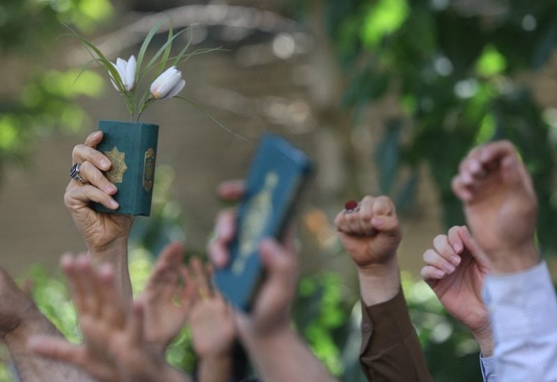 An Iranian protester holds the Quran in his hand during a protest against a man who burned a copy of the Quran outside a mosque in the Swedish capital Stockholm, in front of the Swedish Embassy in Tehran, Iran June 30, 2023. Majid Asgaripour/WANA (West Asia News Agency) via REUTERS ATTENTION EDITORS - THIS PICTURE WAS PROVIDED BY A THIRD PARTY.