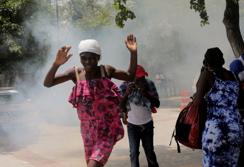 : People move away from tear gas fired by officers of the Haitian National Police while clearing a camp of people escaping the threat of armed gangs, in front of the U.S. Embassy, in Port-au-Prince, Haiti July 25, 2023. REUTERS/Ralph Tedy Erol/File Photo