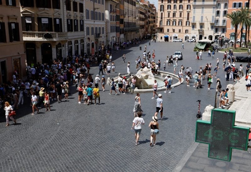 People spend time near the Spanish Steps, during a heatwave across Italy, as temperatures are expected to rise further in the coming days, in Rome, Italy July 18, 2023. REUTERS/Remo Casilli