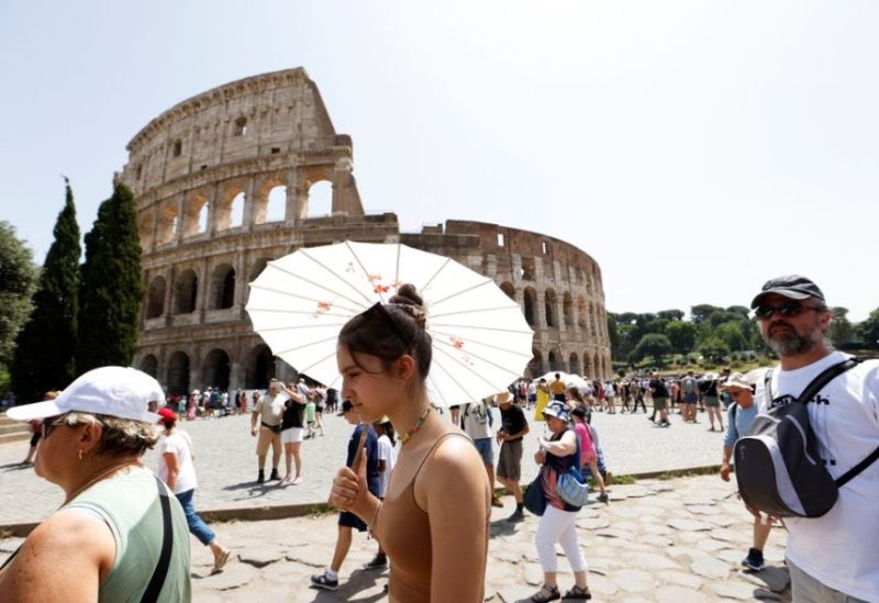 People walk near the Colosseum during a heat wave across Italy as temperatures are expected to rise further in the coming days, in Rome, Italy July 17, 2023. REUTERS