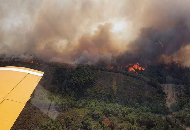 A Turkish firefighting plane flies over a wildfire burning on the island of Rhodes, Greece, July 24, 2023. Turkish Ministry of Agriculture and Forestry/Handout via REUTERS