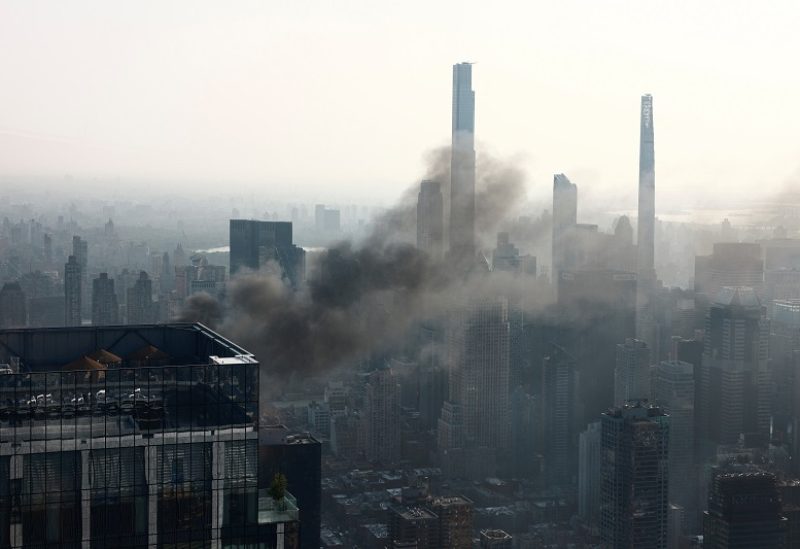 Smoke is visible after a construction crane caught fire on a high-rise building in Manhattan, New York City, U.S., July 26, 2023. REUTERS/Amr Alfiky