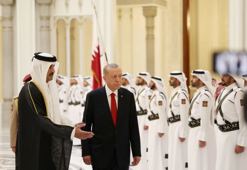 Turkish President Tayyip Erdogan and Qatar's Emir Sheikh Tamim Bin Hamad Al-Thani attend a welcoming ceremony in Doha, Qatar July 18, 2023