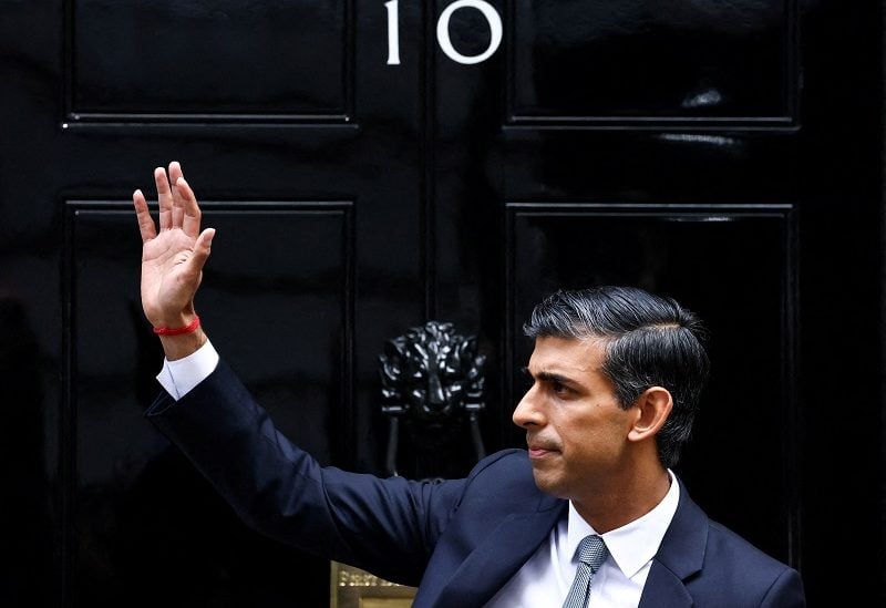 FILE PHOTO: Britain's new Prime Minister Rishi Sunak waves as he enters Number 10 Downing Street, in London, Britain, October 25, 2022. REUTERS/Henry Nicholls/File Photo