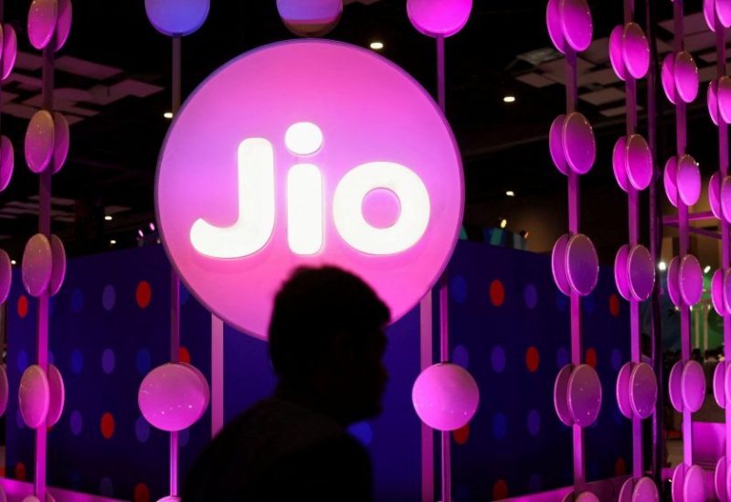 A man walks across the LED board showing the logo of Jio at the ongoing India Mobile Congress 2022, at Pragati Maidan, in New Delhi, India, October 3, 2022. REUTERS/Anushree Fadnavis/File Photo