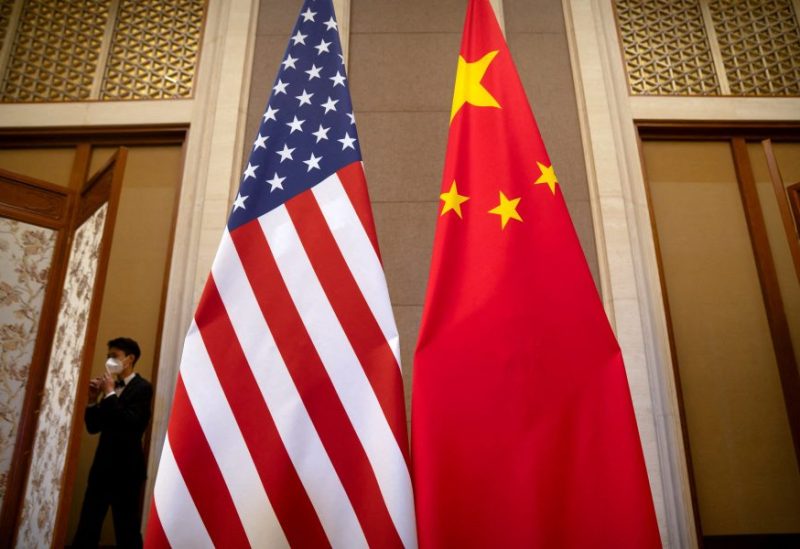 A staff member wearing a face mask walks past United States and Chinese flags set up before a meeting between Treasury Secretary Janet Yellen and Chinese Vice Premier He Lifeng at the Diaoyutai State Guesthouse in Beijing, China, Saturday, July 8, 2023. Mark Schiefelbein/Pool via REUTERS/File Photo