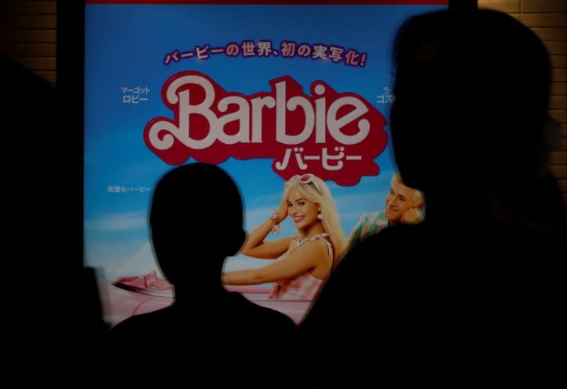 People walk past a promotional poster of film "Barbie" in Tokyo, Japan, August 3, 2023. REUTERS/Kim Kyung-Hoon