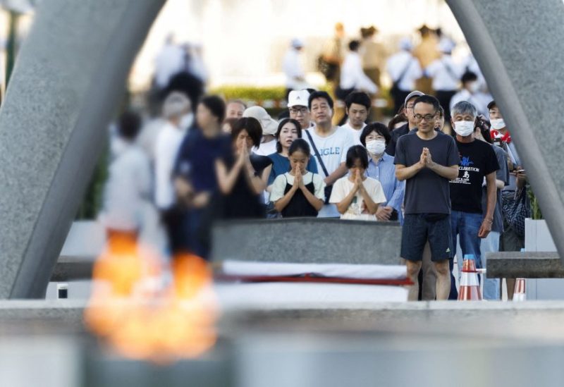 People pray in front of the cenotaph for the victims of the 1945 atomic bombing, on the anniversary of the world's first atomic bombing, at Peace Memorial Park in Hiroshima, western Japan, in this photo taken by Kyodo on August 6, 2023. Mandatory credit Kyodo/via REUTERS