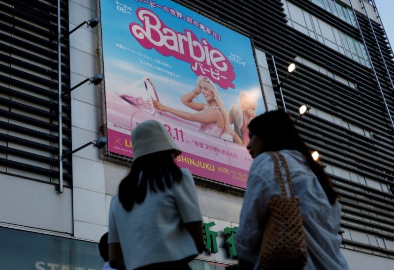 Women stand in front of a promotional poster of film "Barbie" in Tokyo, Japan, August 3, 2023. REUTERS/Kim Kyung-Hoon/File Photo