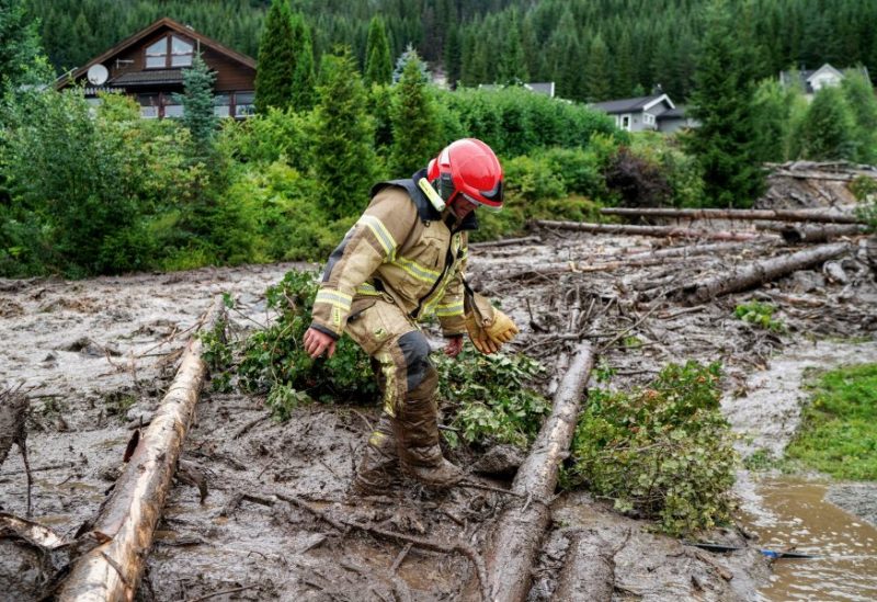 A person walks in mud after extreme weather Hans hit Valdres, near Oslo, Norway August 8, 2023. NTB/Cornelius Poppe via REUTERS