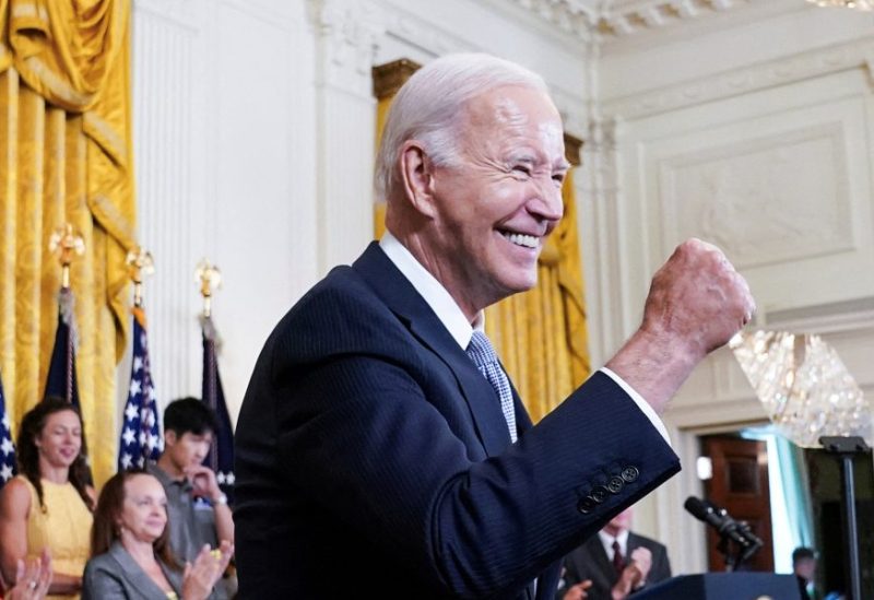 U.S. President Joe Biden gives a fist bump salute to the audience during an event to celebrate the anniversary of his signing of the 2022 Inflation Reduction Act legislation, in the East Room of the White House in Washington, U.S., August 16, 2023. REUTERS/Kevin Lamarque/File Photo