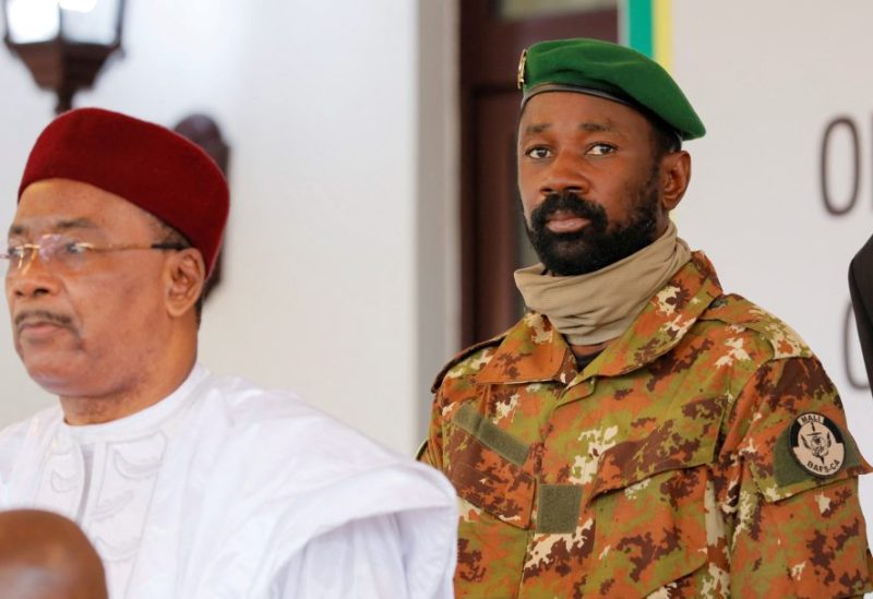 Colonel Assimi Goita, leader of Malian military junta, looks on while he stands behind Niger's President Mahamadou Issoufou during a photo opportunity after the Economic Community of West African States (ECOWAS) consultative meeting in Accra, Ghana September 15, 2020. REUTERS/Francis Kokoroko/File Photo