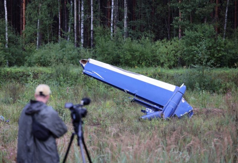 A cameraman films a wreckage of the private jet linked to Wagner mercenary chief Yevgeny Prigozhin near the crash site in the Tver region, Russia, August 24. REUTERS/Marina Lystseva