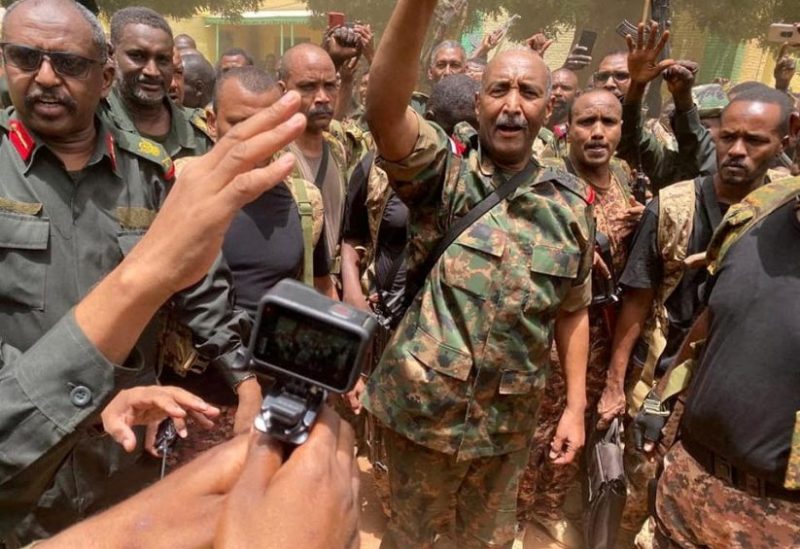 Sudan's General Abdel Fattah al-Burhan stands among troops,in an unknown location, in this picture released on May 30, 2023. Sudanese Armed Forces/Handout via REUTERS/File Photo