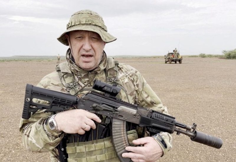 Yevgeny Prigozhin, chief of Russian private mercenary group Wagner, gives an address in camouflage and with a weapon in his hands in a desert area at an unknown location, in this still image taken from video possibly shot in Africa and published August 21, 2023. Courtesy PMC Wagner via Telegram via REUTERS/File photo