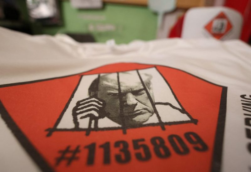 T-shirts and hats with an image depicting the mugshot of former President Donald Trump are pictured at the Y-Que printing store in Los Angeles, California, U.S., August 25, 2023. REUTERS/Mario Anzuoni