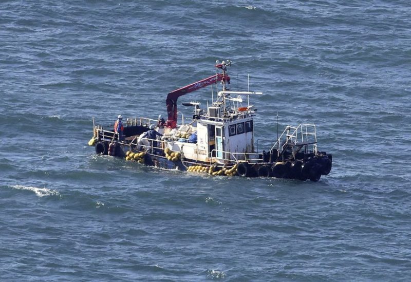 A boat collecting seawater for monitoring radioactive materials in the sea is seen near the Fukushima Daiichi Nuclear Power Plant, after the nuclear power plant started releasing treated radioactive water into the Pacific Ocean, in Okuma, Fukushima prefecture, Japan August 24, 2023, in this photo