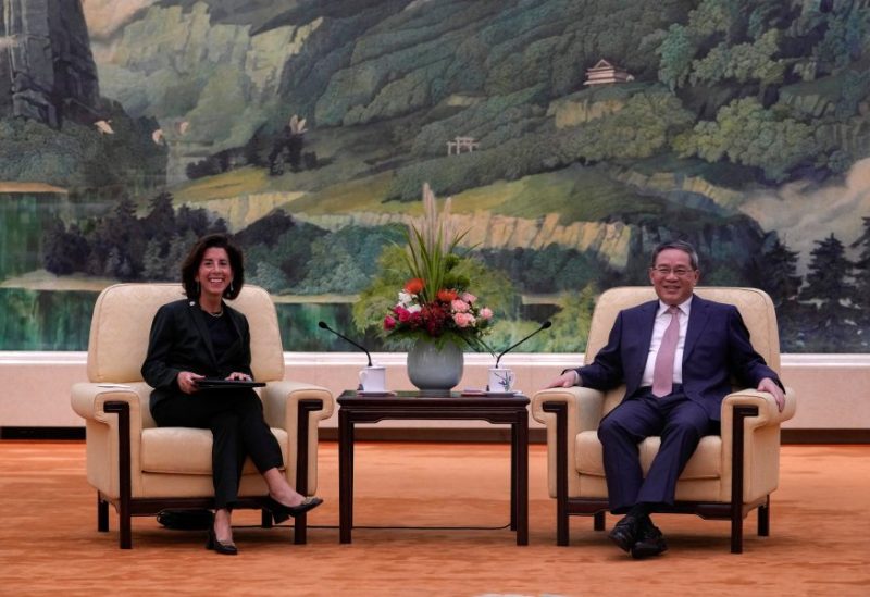 U.S. Commerce Secretary Gina Raimondo and Chinese Premier Li Qiang have a light moment during a meeting at the Great Hall of the People in Beijing, China, August 29, 2023. Andy Wong/Pool via REUTERS