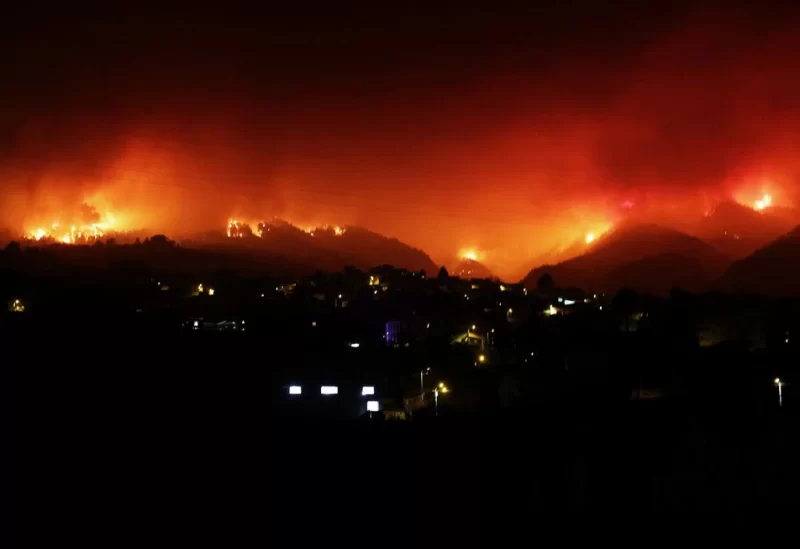 A view shows fire over the mountains in the village of La Victoria, as wildfires rage out of control on the island of Tenerife, Canary Islands, Spain August 19, 2023. REUTERS