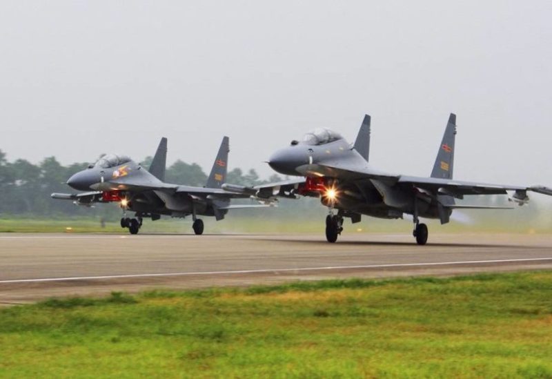 In this undated file photo released on Aug. 6, 2016, by China's Xinhua News Agency, two Chinese Su-30 fighter jets take off from an unspecified location to fly a patrol over the South China Sea. (Xinhua via AP, File)