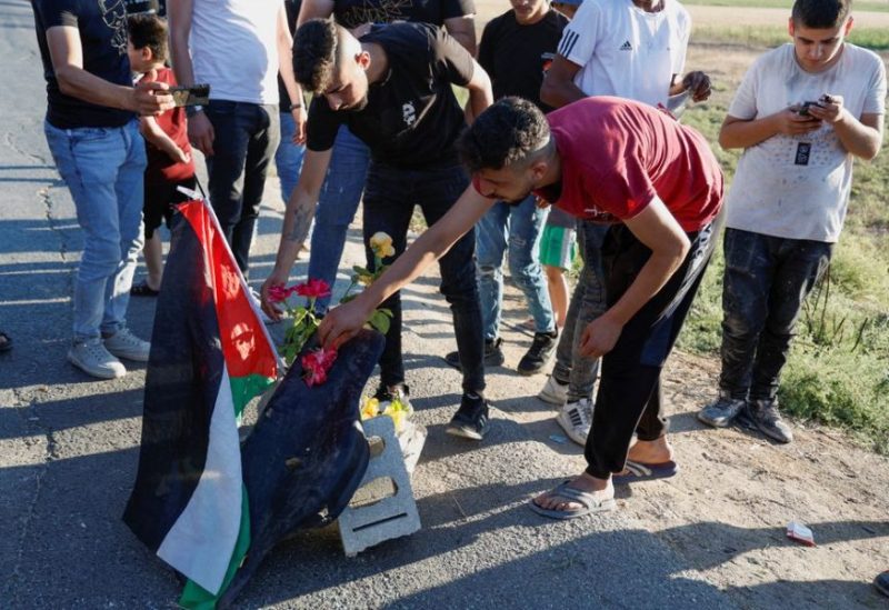 Palestinians gather at the scene where Israeli forces targeted a Palestinian car, near Jenin, in the Israeli-occupied West Bank August 6, 2023. REUTERS