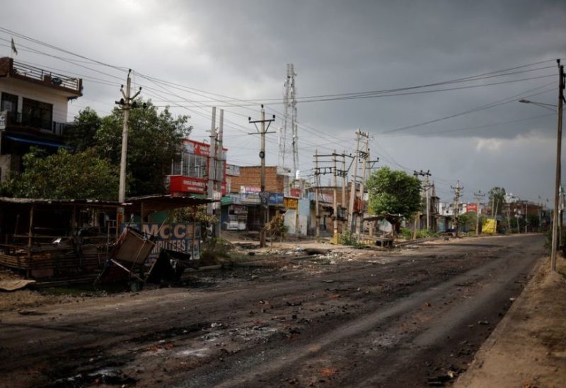 A burnt shop is seen next to a deserted road during a curfew imposed by the authorities following clashes between Hindus and Muslims in Nuh district of the northern state of Haryana, India, August 1, 2023. REUTERS