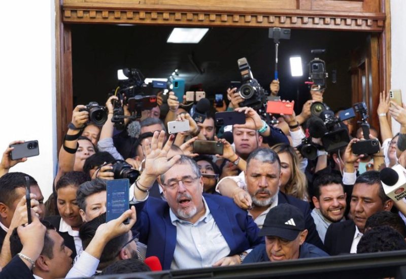 Guatemalan anti-graft presidential candidate Bernardo Arevalo, of the Semilla political party, waves next to media members during the presidential run-off election, in Guatemala City, Guatemala August 20, 2023. REUTERS