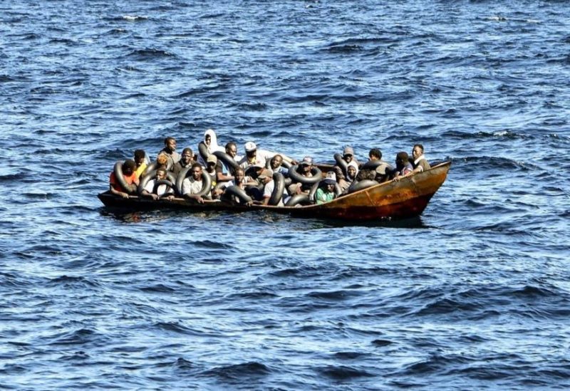 Migrants of African origin trying to flee to Europe are crammed on board of a small boat, as Tunisian coast guards prepare to transfer them onto their vessel, at sea between Tunisia and Italy, on August 10, 2023. (AFP)