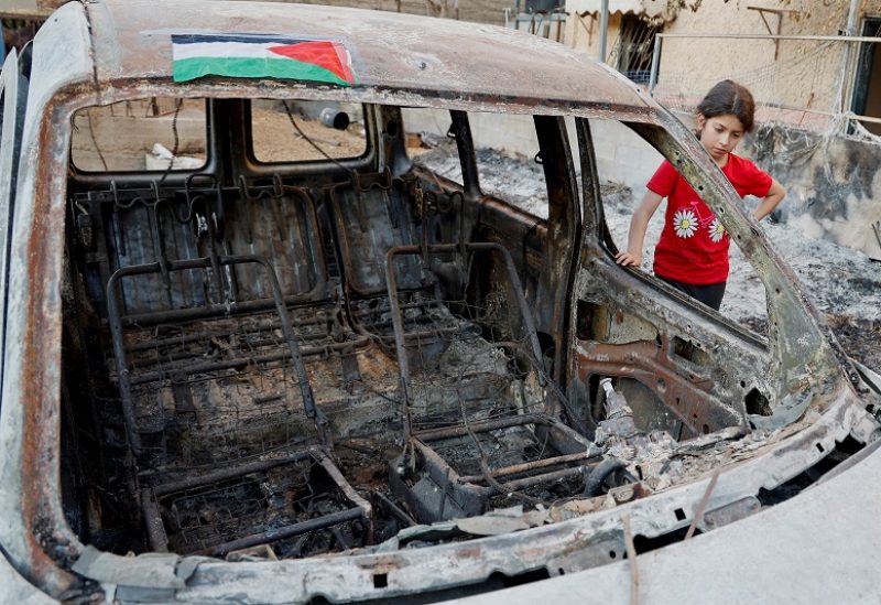 A Palestinian girl stands next to a wrecked vehicle following an Israeli military operation, in Jenin in the Israeli-occupied West Bank July 10, 2023. REUTERS/Raneen Sawafta TPX IMAGES OF THE DAY