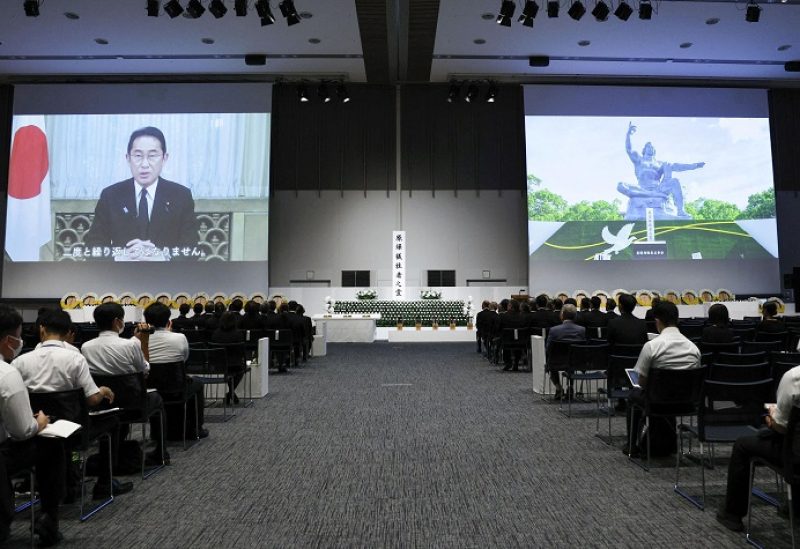 Huge screens show a video message by Japan's Prime Minister Fumio Kishida and the Peace Statue at Nagasaki Peace Park during a ceremony commemorating the 78th anniversary of the bombing of the city, following a change in venue and scaling down of the ceremony due to Typhoon Khanun approaching, at Dejima Messe Nagasaki in Nagasaki, Japan, August 9, 2023, in this photo taken by Kyodo. Mandatory credit Kyodo via REUTERS ATTENTION EDITORS