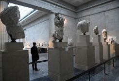 An employee poses as he views examples of the Parthenon sculptures, sometimes referred to in the UK as the Elgin Marbles, on display at the British Museum in London, Britain, January 25, 2023. REUTERS