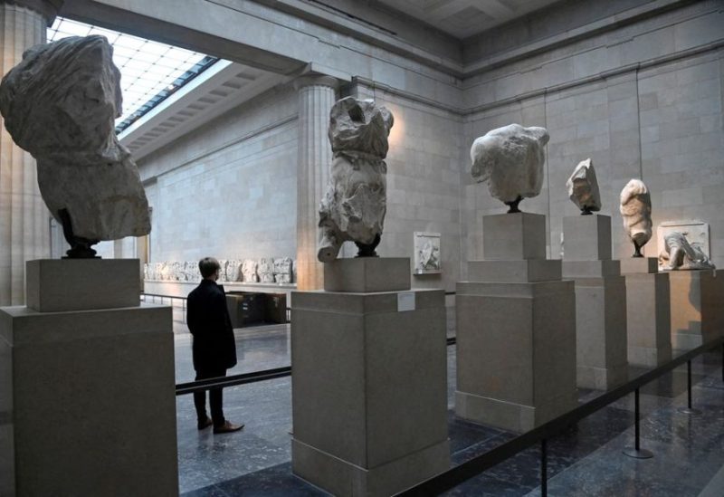 An employee poses as he views examples of the Parthenon sculptures, sometimes referred to in the UK as the Elgin Marbles, on display at the British Museum in London, Britain, January 25, 2023. REUTERS