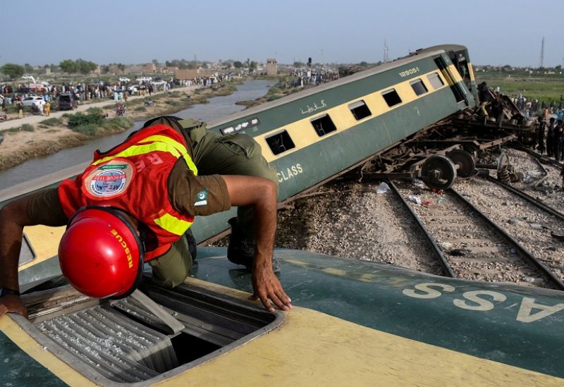 A rescue worker searches for victims after a train derailed in Sarhari town in district Sanghar, Pakistan August 6, 2023. REUTERS/Yasir Rajput TPX IMAGES OF THE DAY