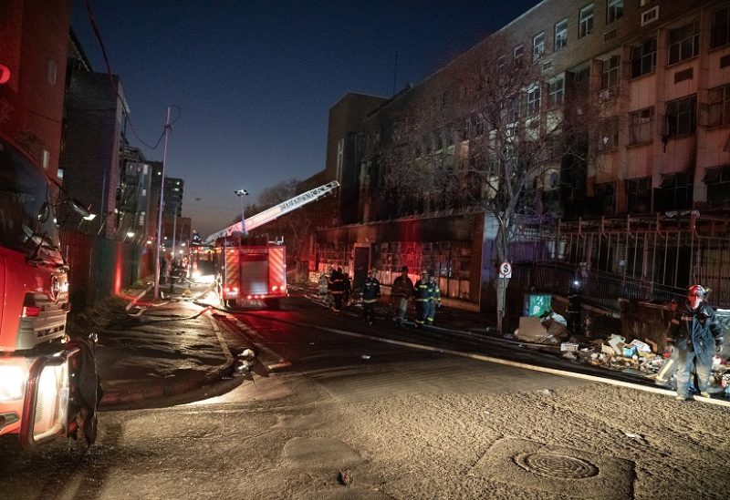 Fire fighters work at the scene of a deadly blaze in the early hours of the morning, in Johannesburg, South Africa August 31, 2023. REUTERS/Shiraaz Mohamed