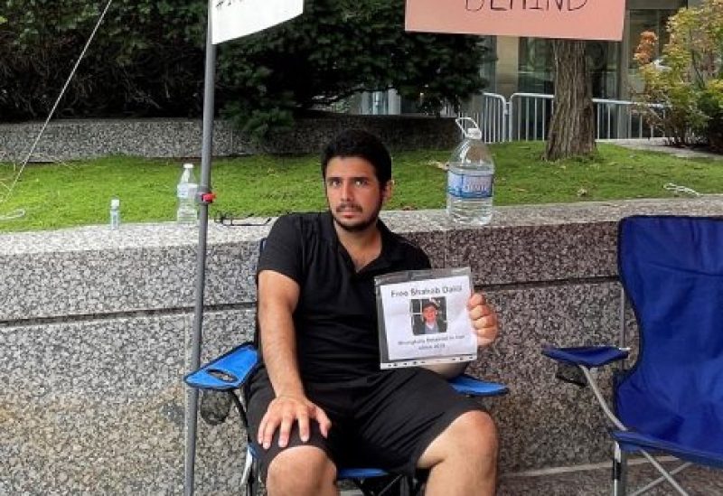 Darian Dalili sits outside the U.S. State Department protesting and engaging in a hunger strike in support of the release by Iran of his father Shahab Dalili, 60, a U.S. permanent resident who has been detained in Iran since 2016, but who was excluded from last week's deal which could eventually result in the release of five Americans jailed in Iran, in Washington, U.S. August 15, 2023. REUTERS/Humeyra Pamuk