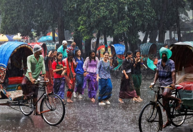 Indigenous women walk on the street during rain after celebrating the International Day of the World's Indigenous Peoples in Dhaka, Bangladesh, August 9, 2023. REUTERS/Mohammad Ponir Hossain