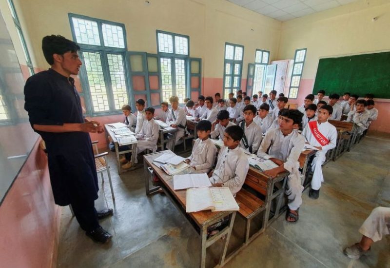 Israr Ahmed, (R - 2nd row) who survived after being rescued from a stranded cable car, sits with other children in a classroom at a school in Battagram, Pakistan, August 23, 2023. REUTERS