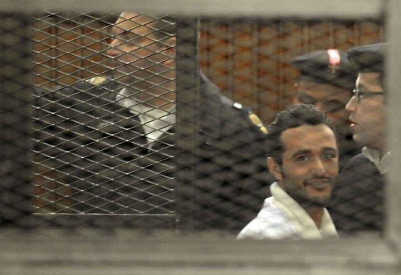 Political activist Ahmed Douma of the 6 April movement looks on behind bars in Cairo, December 22, 2013. REUTERS