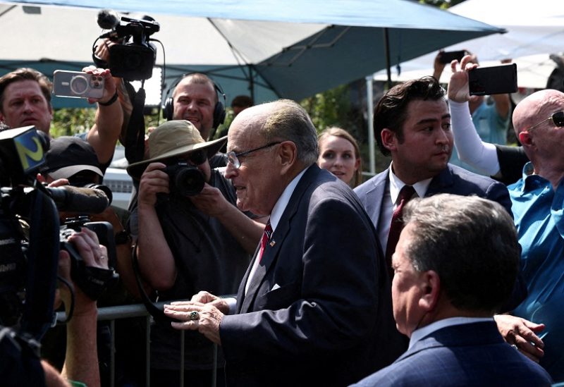 Former New York City Mayor Rudy Giuliani speaks to reporters outside the Fulton County Jail after surrendering to face state charges arising from actions he is accused of taking to overturn former U.S. President Donald Trump's 2020 election loss, in Atlanta, Georgia, U.S., August 23, 2023. REUTERS/Dustin Chambers REFILE - CORRECTING "MAYOR" TO "FORMER NEW YORK CITY MAYOR\