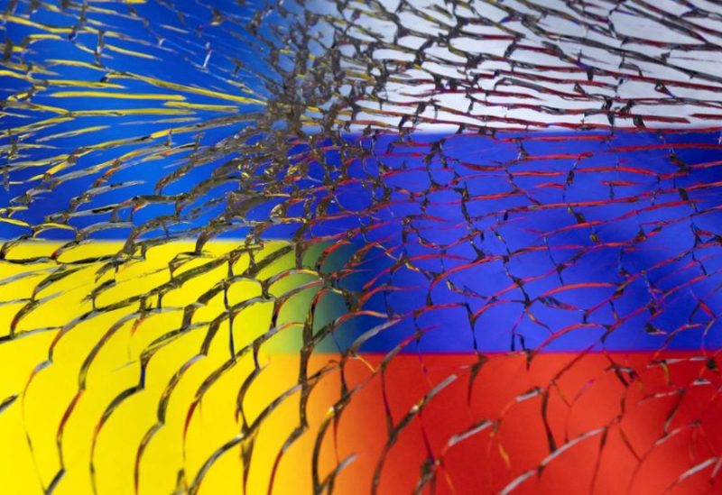 Ukraine and Russian flags are seen through broken glass in this illustration taken March 1, 2022. REUTERS