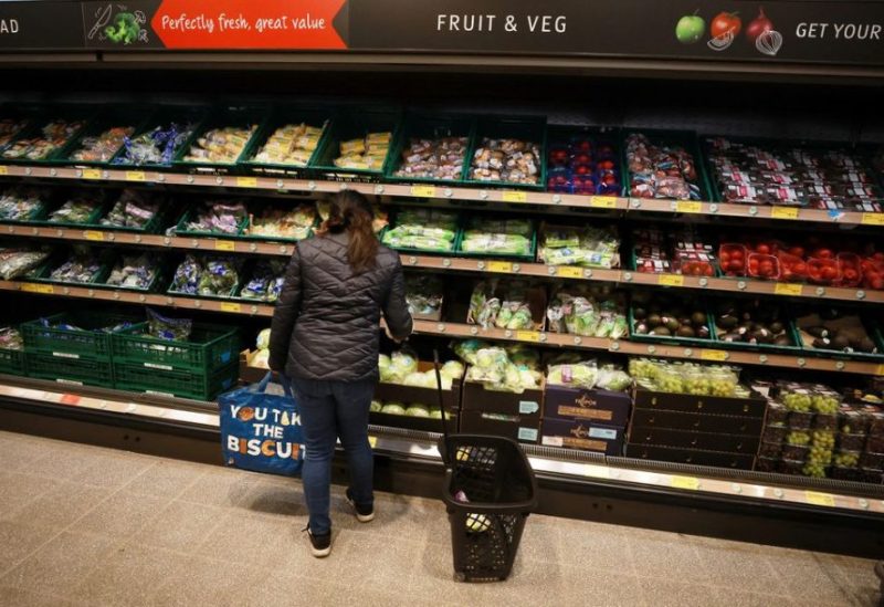 A shopper looks at fruit and vegetables inside an ALDI supermarket near Altrincham, Britain, February 20, 2023. REUTERS