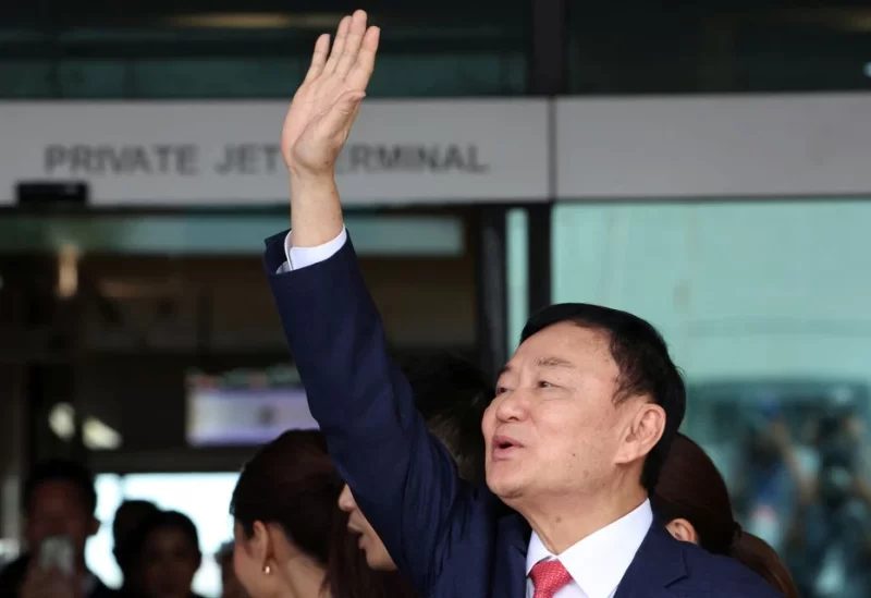 Former Thai Prime Minister Thaksin Shinawatra, who is expected to be arrested upon his return as he ends almost two decades of self-imposed exile, waves at Don Mueang airport in Bangkok, Thailand August 22, 2023. REUTERS