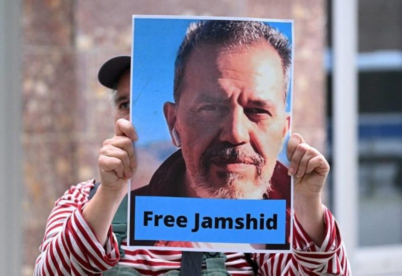 A demonstrator holds a picture of Iranian-German Jamshid Sharmahd, who has been sentenced to death in Iran, and with the lettering "Free Jamshid" during a demonstration for his release in front of the German Foreign Ministry in Berlin on July 31, 2023. (AFP)