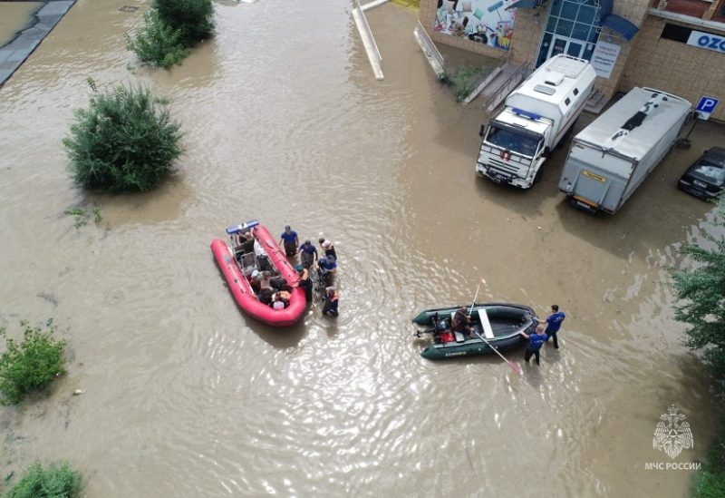 Rescuers use inflatable boats to evacuate residents of the area flooded due to a dam break in Ussuriysk, Russia, in this still image taken from video released August 12, 2023. Russian Emergencies Ministry/Handout via REUTERS ATTENTION EDITORS - THIS IMAGE WAS PROVIDED BY A THIRD PARTY. NO RESALES. NO ARCHIVES. MANDATORY CREDIT
