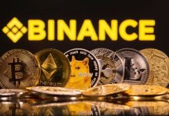 Representations of cryptocurrencies Bitcoin, Ethereum, DogeCoin, Ripple, and Litecoin are seen in front of a displayed Binance logo in this illustration taken, June 28, 2021. REUTERS/Dado Ruvic/Illustration/File photo