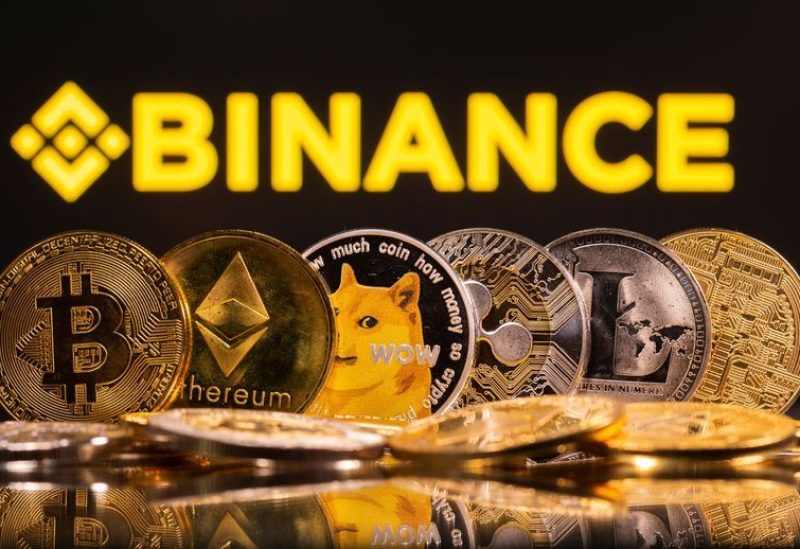 Representations of cryptocurrencies Bitcoin, Ethereum, DogeCoin, Ripple, and Litecoin are seen in front of a displayed Binance logo in this illustration taken, June 28, 2021. REUTERS/Dado Ruvic/Illustration/File photo