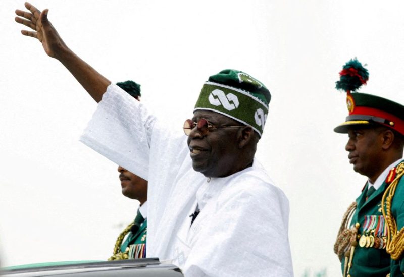Nigeria's President Bola Tinubu waves to a crowd as he takes the traditional ride on top of a ceremonial vehicle, after his swearing-in ceremony in Abuja, Nigeria May 29, 2023. REUTERS/Temilade Adelaja//File Photo