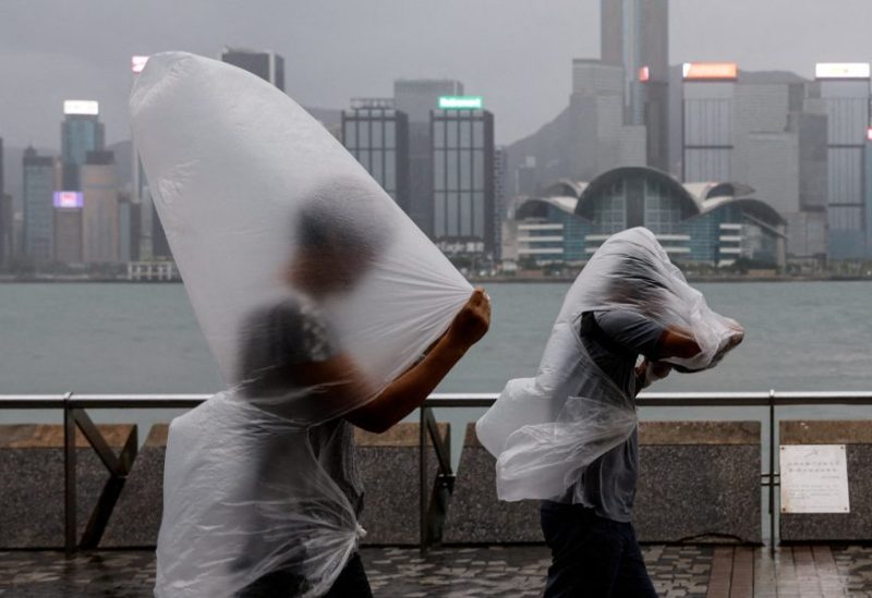 People brave strong winds as Super Typhoon Saola approaches, in Hong Kong, China September 1, 2023. REUTERS/Tyrone Siu